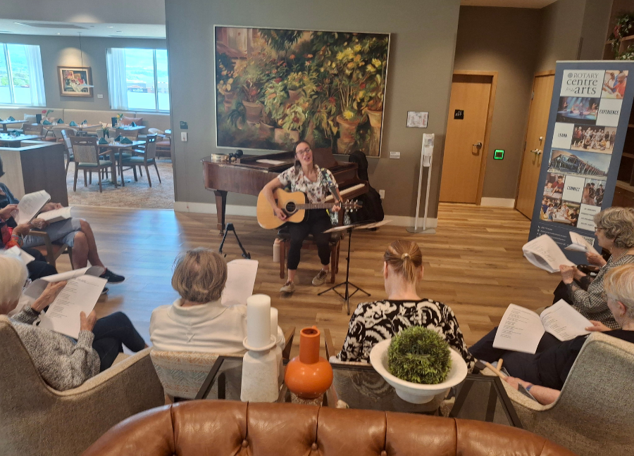 PARCS residents singing with Emily playing the guitar