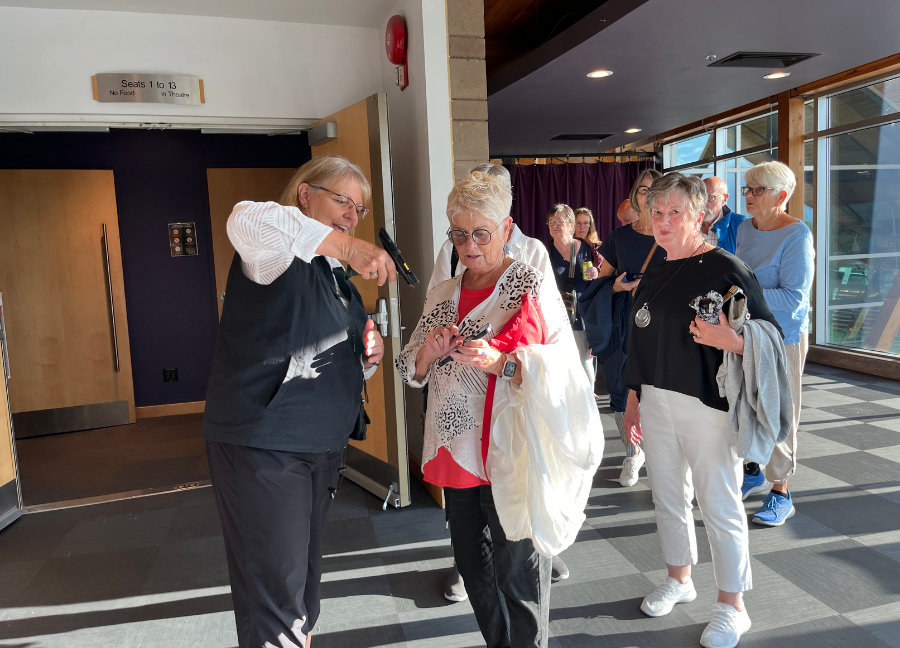 Rotary Centre for the Arts volunteers scan tickets and direct guests to their seats for the screening of Eddy's Kingdom
